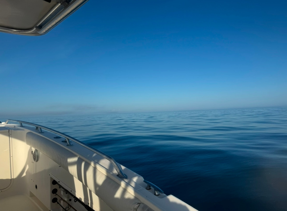 Flat calm Gulf of Mexico morning seen over the gunwale