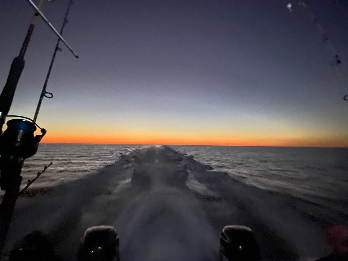 Wake behind the boat running offshore at sunrise